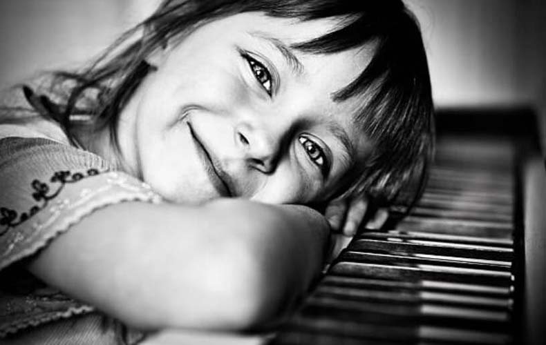 Small girl playing on a xylophone.